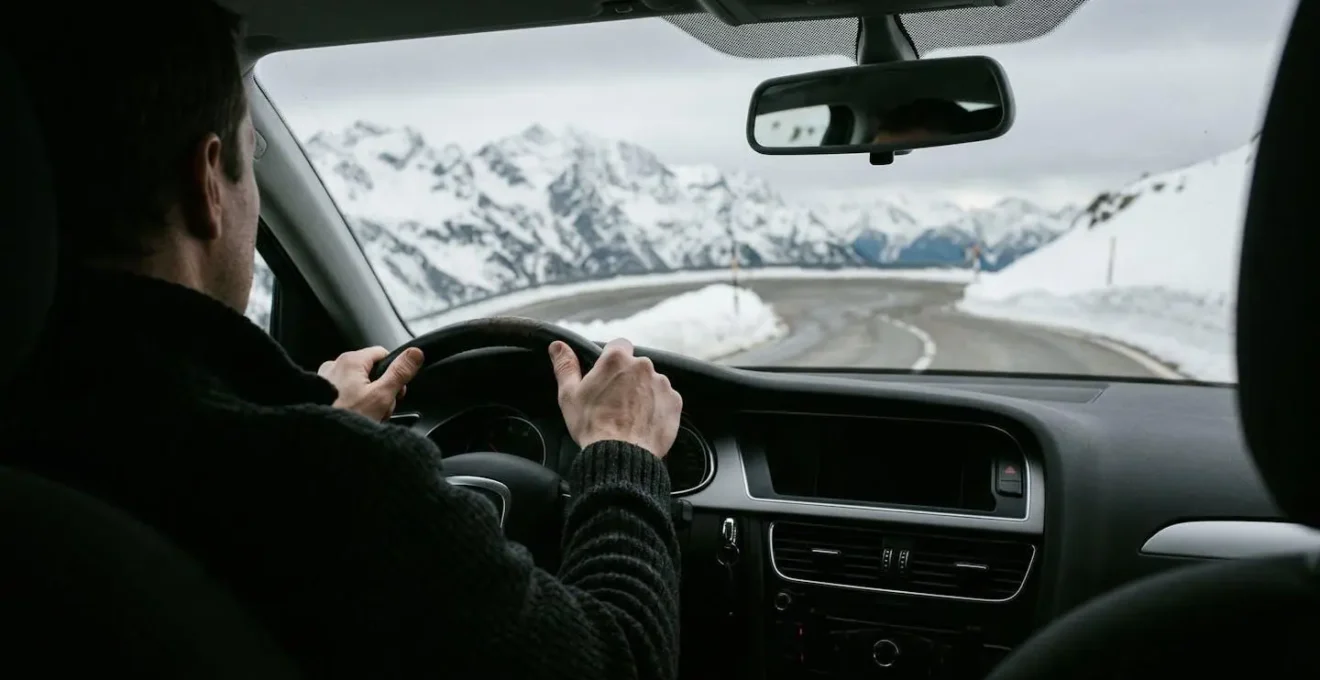 Nederlandse auto op besneeuwde bergweg in de Alpen